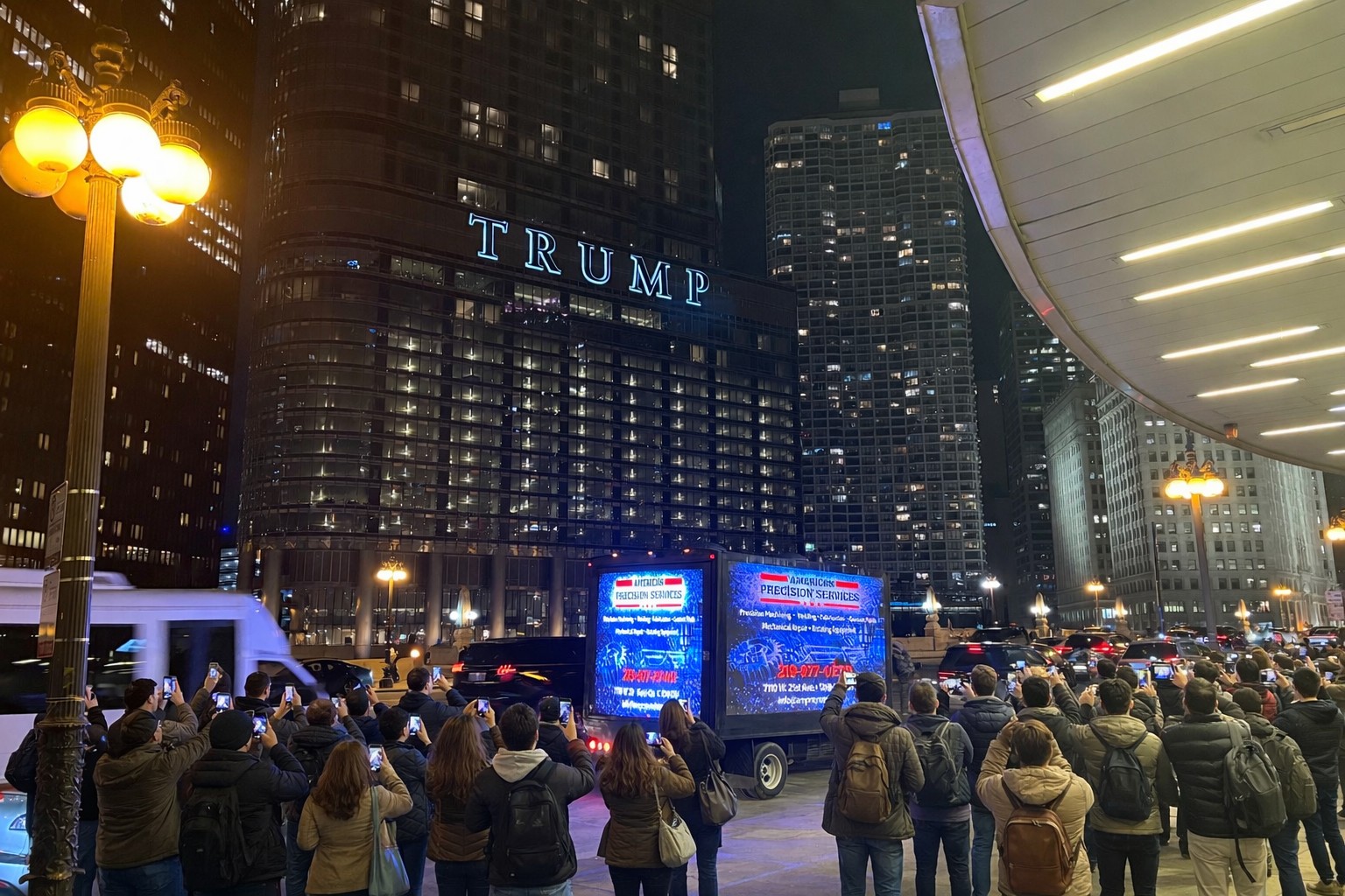 Crowd photographing the AOTC LED truck for American Precision Services on the Chicago River near Trump Tower at night