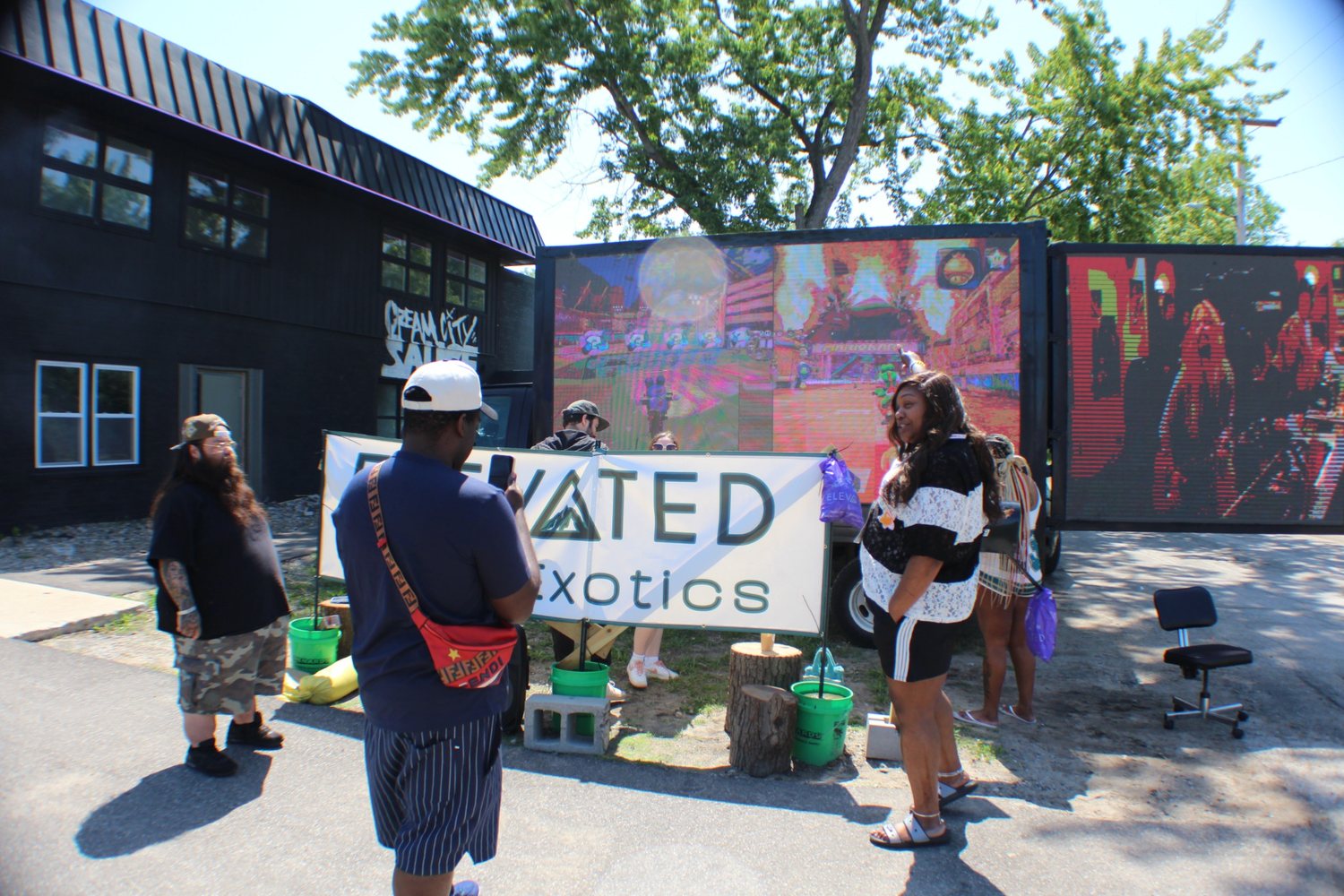 Customers gathered around the AOTC screens at an Elevated Exotics engagement stop