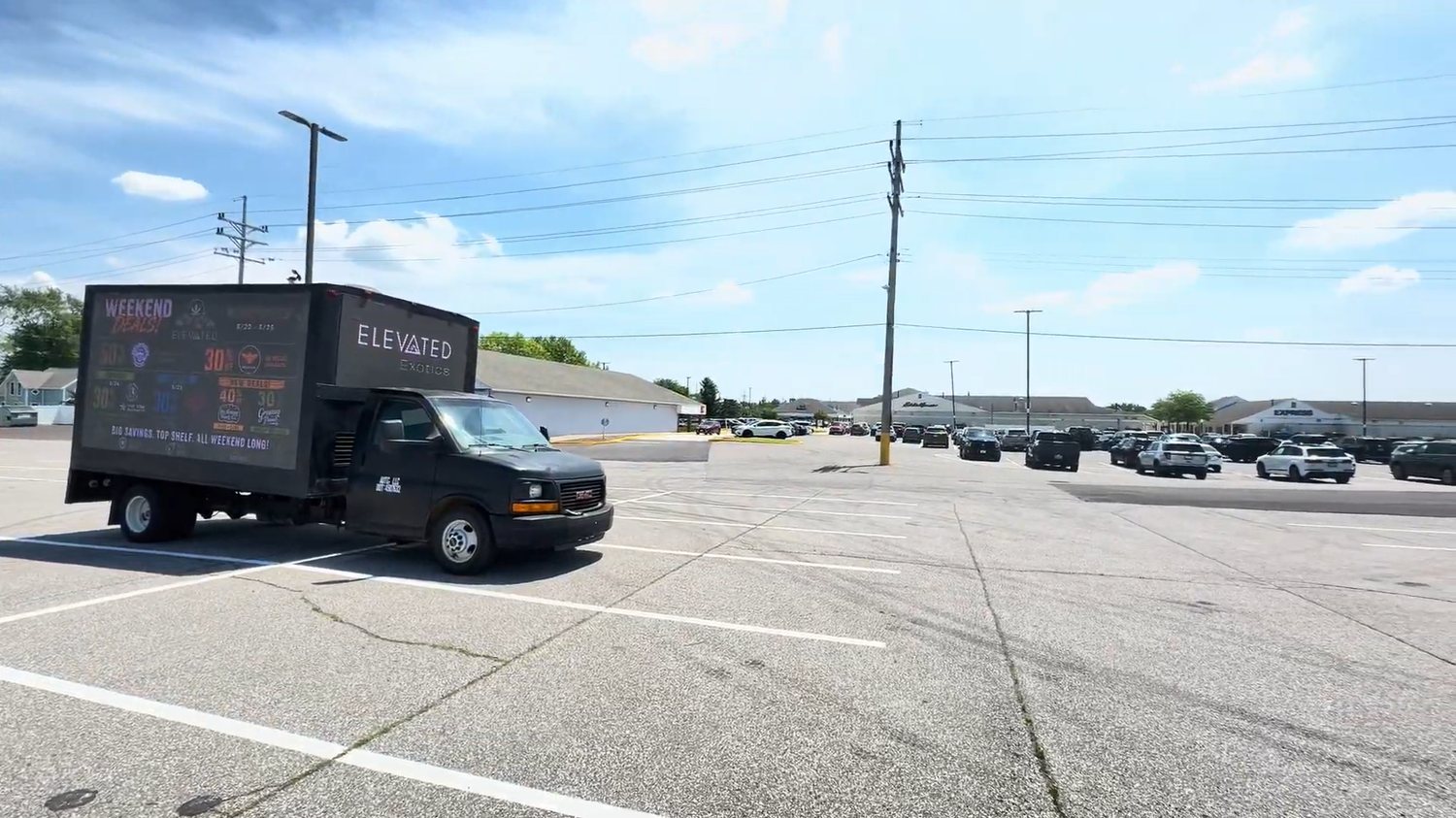 AOTC mobile LED truck for Elevated Exotics parked in a retail parking lot