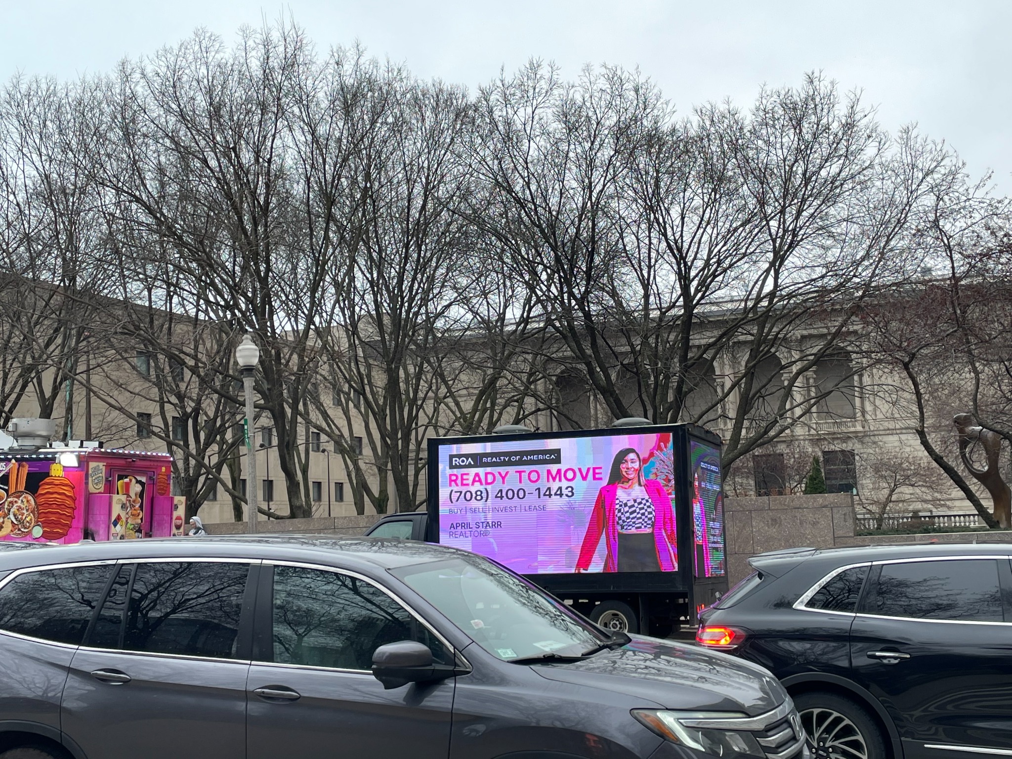 AOTC mobile LED truck for Realty of America in downtown Chicago traffic during the day