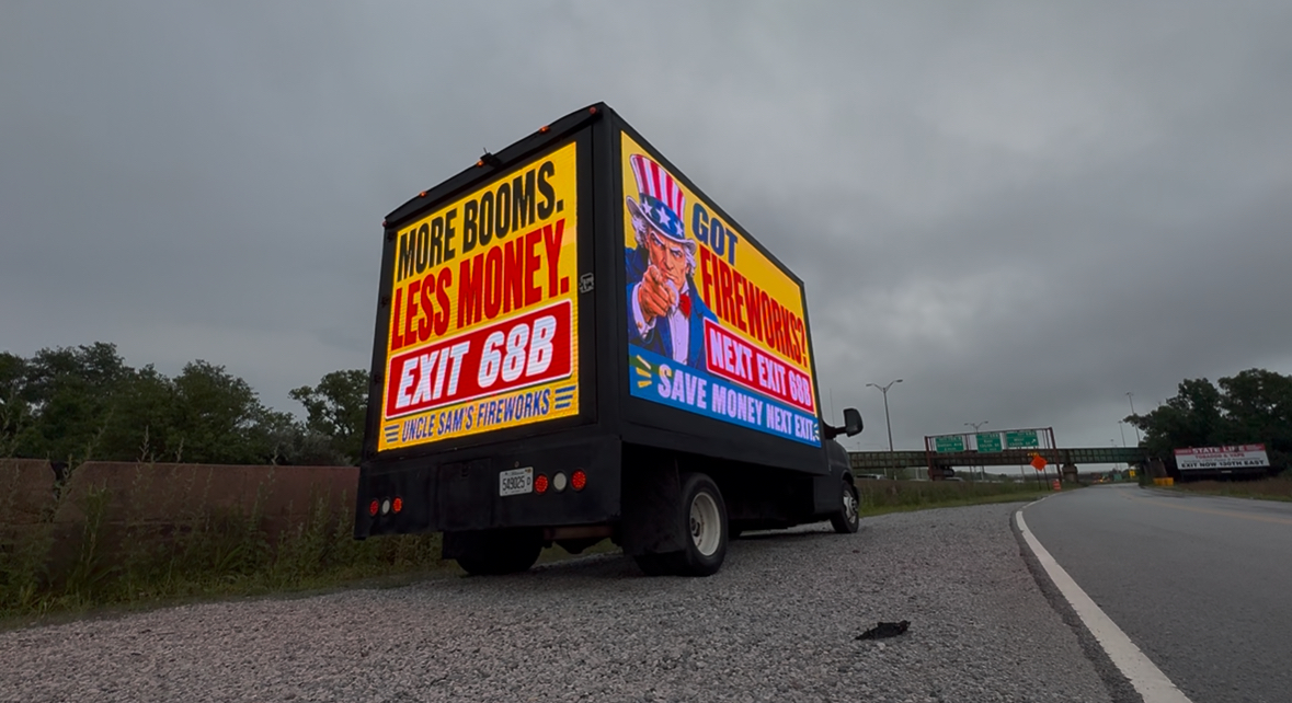 AOTC LED truck for Uncle Sam's Fireworks on the highway shoulder during stormy conditions