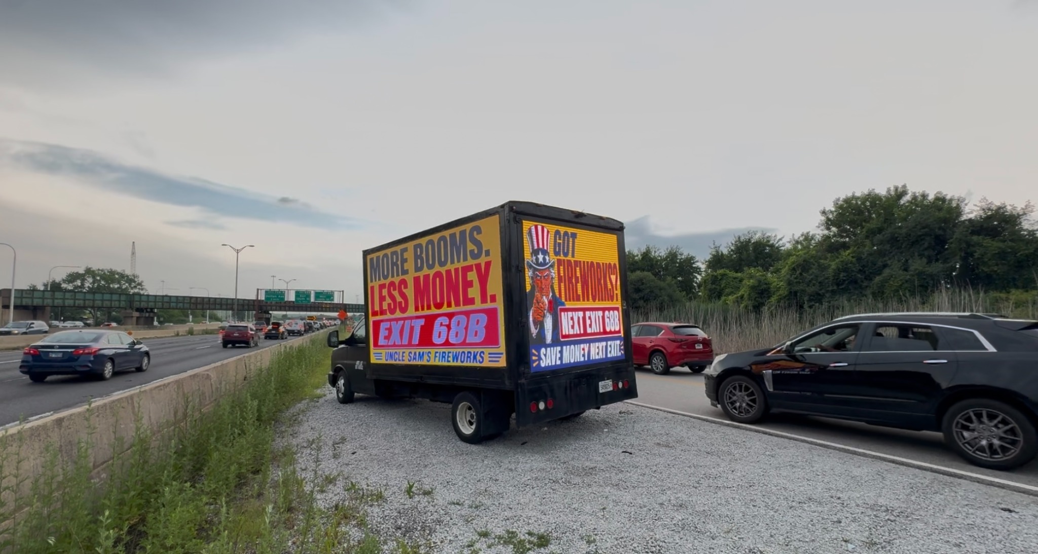 AOTC LED truck for Uncle Sam's Fireworks alongside I-94 traffic before Exit 68B