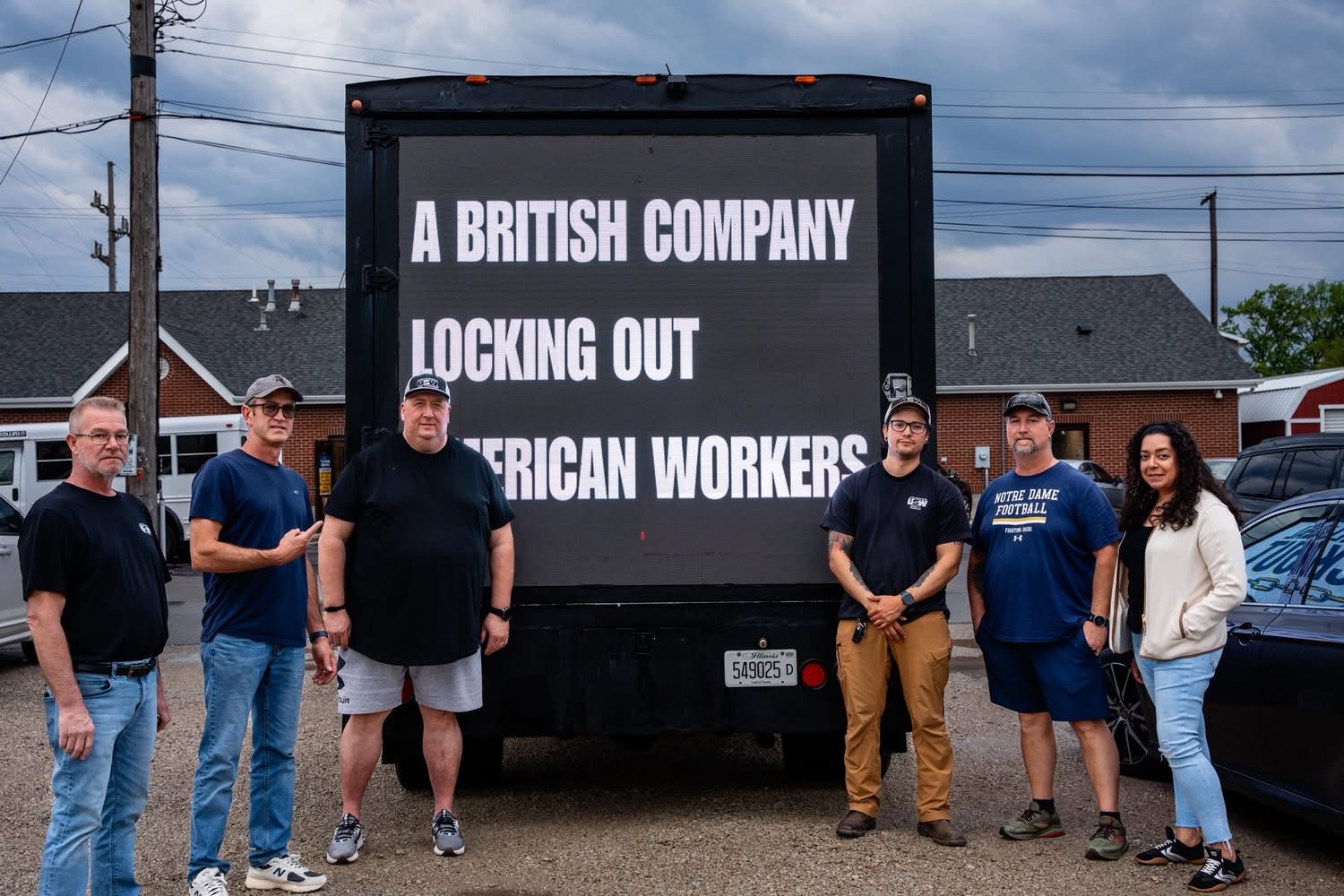 USW Local 7-1 workers and organizers standing in front of the AOTC LED truck displaying the lockout message