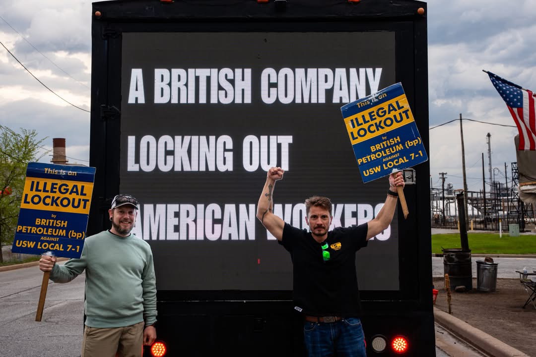USW workers holding illegal lockout signs in front of the AOTC LED truck near the BP facility